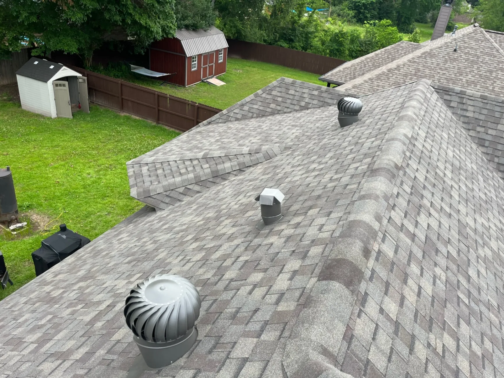 Roofing crew inspecting shingles after a storm